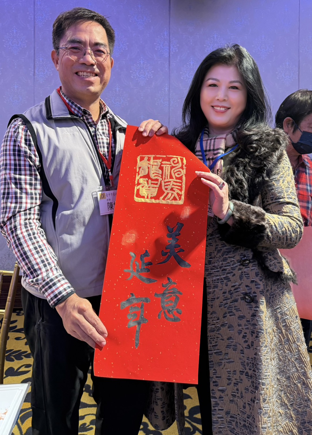 書法家陳世澤(左)現場揮毫並致贈「美意延年」春聯予新聞工會理事長,筆墨傳情,為會員大會增添濃厚人文氣息與年節祝福。