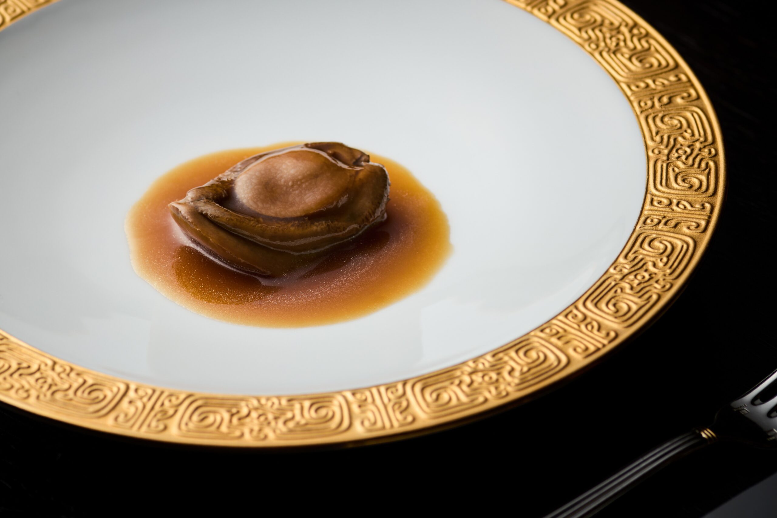 招牌菜「源·公館鮑魚」嚴選優質「舊水鮑魚」（乾鮑魚），以矜貴花膠慢煨收汁，鮑魚軟糯溏心，盡顯「以珍饈入味，吃其神而不見其形」的奢華哲學。