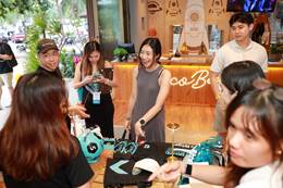 A group of people standing around a table AI-generated content may be incorrect.